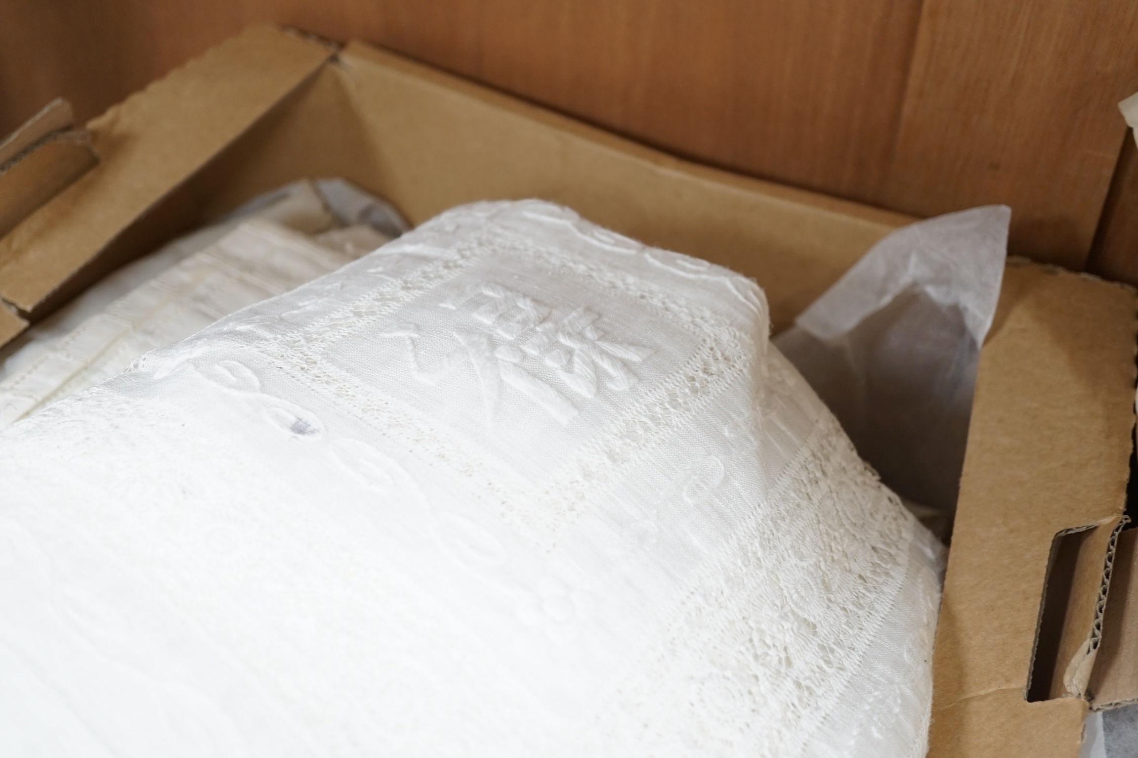 A collection of embroidered and crochet edged table linen, three silk boudoir cushions and a pin cushion. Condition - the linen needs re-laundering and silk cushions have some staining